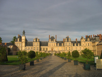 A view of the front Fontainebleau Chateau during sunset